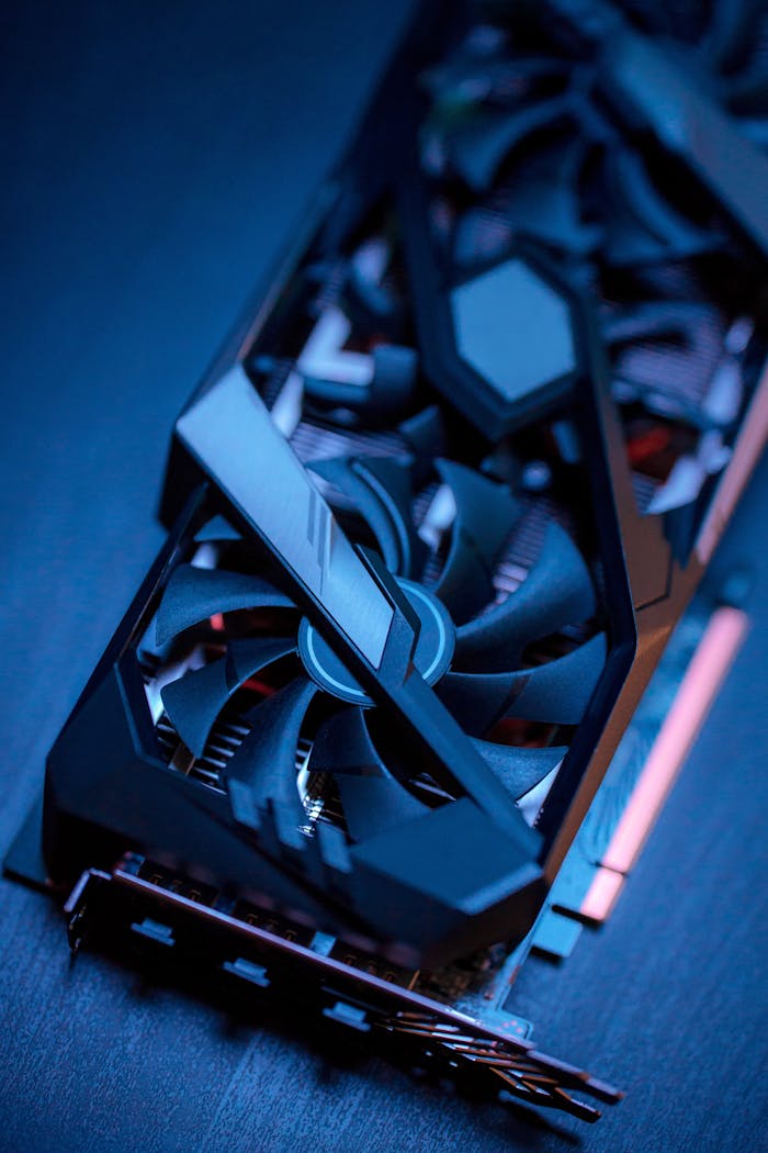 Detailed view of a high-performance graphics card with cooling fans, ideal for gaming PCs.